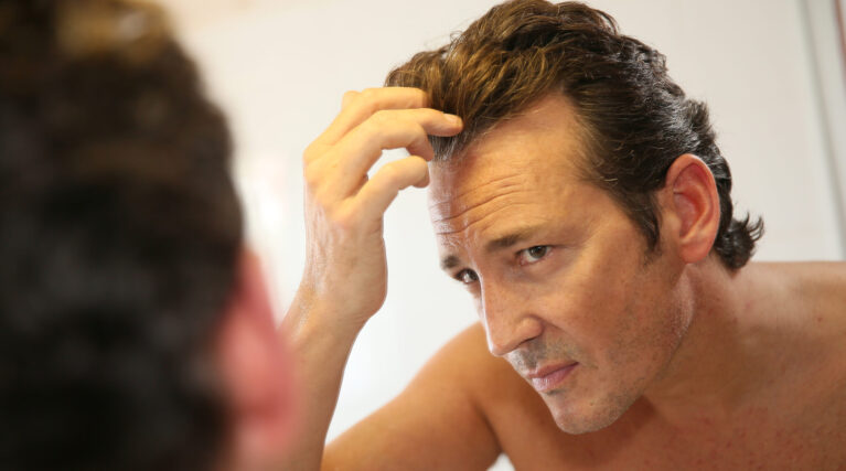 man-inspecting-his-hair-in-a-mirror-2026-04-13-23-34-13-utc man-inspecting-his-hair-in-a-mirror-2026-04-13-23-34-13-utc