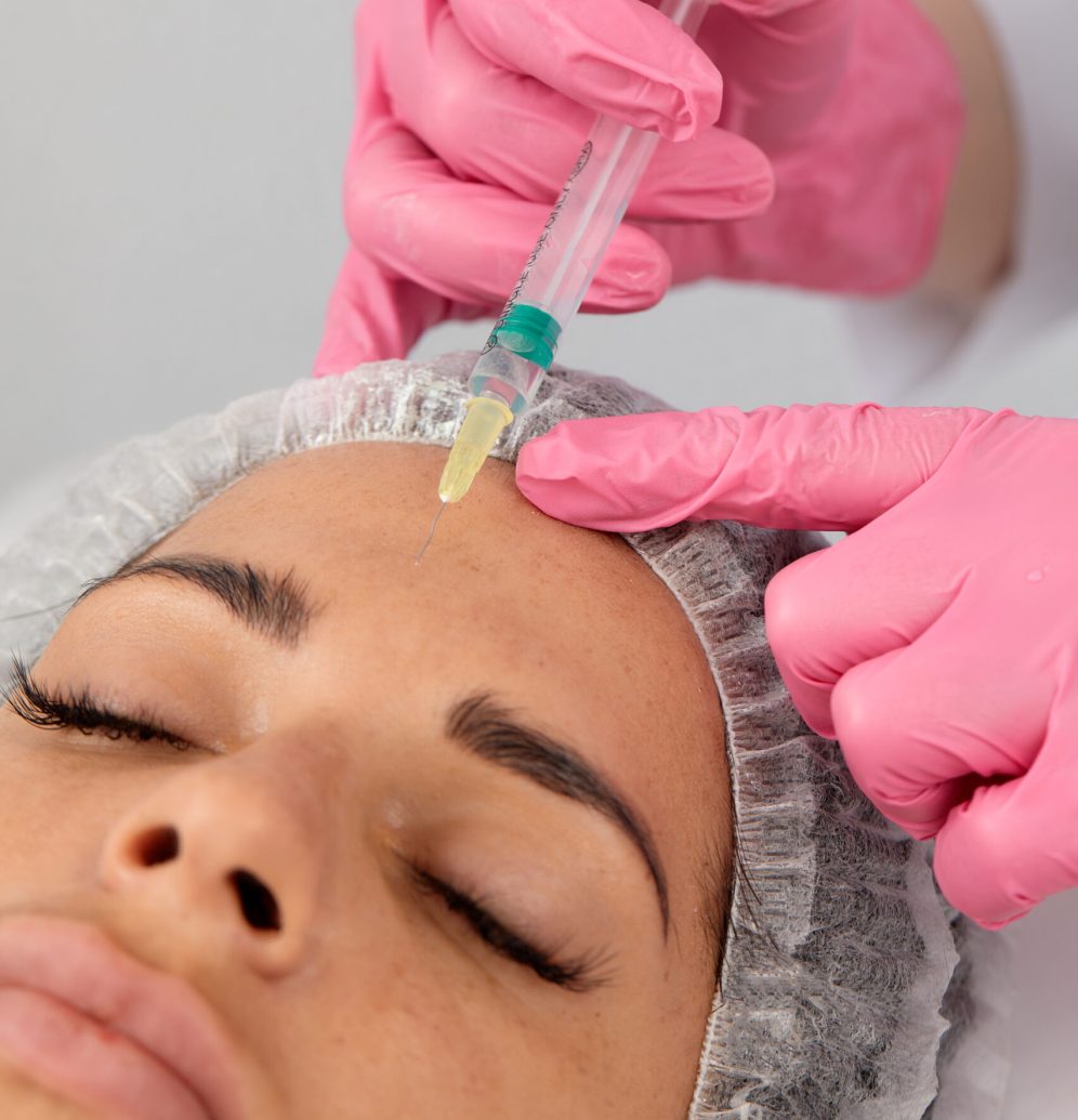 Portrait of young Caucasian woman getting botox cosmetic injection in forehead. Beautiful woman gets botox injection in her face.